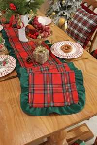 Detail shot of Christmas plaid table runner featuring green ruffle edge for holiday decor.