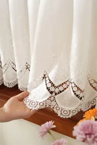 French white embroidered hollow lace curtain detail showing exquisite craftsmanship for home decor.