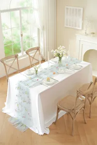 Elegant floral embroidered table runner detail, sheer tulle table decor for weddings and dining.