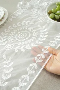 White lace embroidered table runner with elegant floral leaf pattern for wedding home decor.