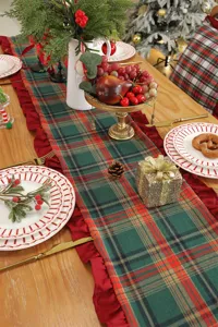 Christmas plaid table runner detail showing festive table setting with red ruffle trim.