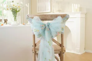 Elegant blue floral embroidered chair sash for wedding decor, sheer tulle bow ribbon detail.