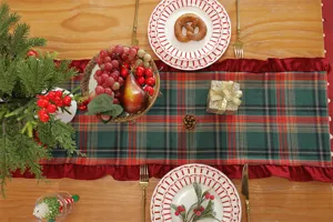 Christmas plaid table runner with ruffles, red and green festive table decor for holiday party.