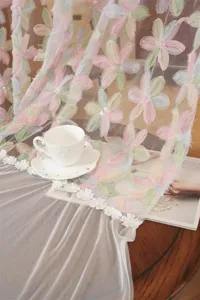 Close-up detail of French style embroidered floral lace sheer curtain with colorful 3D flowers.