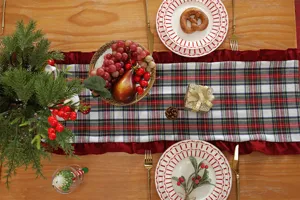 Detailed shot of Christmas plaid table runner with ruffled edge, festive home decor textile.