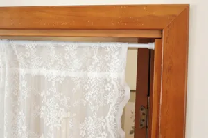 White lace door curtain with floral embroidery and tension rod, perfect for french style home decor.