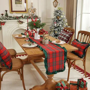 Christmas plaid table runner with ruffles and matching decorative pillows for holiday home decor.
