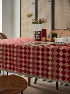 Elegant red and beige checkered tablecloth with delicate gold lace border for dining table home decor.