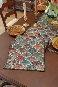 Detailed view of vintage style jacquard table runner with decorative shell edge and retro pattern.