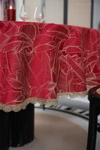 Elegant red jacquard round tablecloth with gold leaf pattern and lace trim detail.