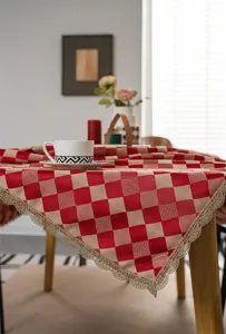 Red and beige checkered jacquard tablecloth with elegant golden lace trim, detailed fabric texture view.