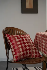Red and beige checkered throw pillow, classic woven cushion for living room and bedroom decor.