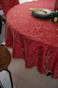 Festive red round tablecloth with gold leaf jacquard and elegant lace trim for dining table.