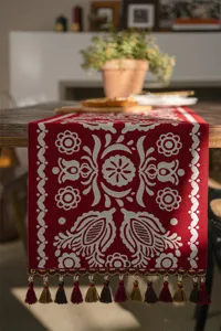Red jacquard table runner with fringe, elegant floral design for dining room home decor.