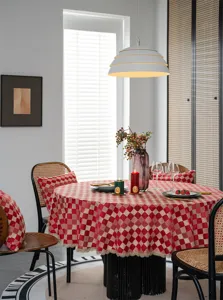 Red checkered waterproof round tablecloth with gold lace trim for festive dining room decor.