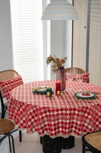 Detailed view of the red and beige checkered tablecloth with elegant lace trim on table.