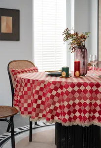 Detailed lifestyle scene showing red waterproof round tablecloth with elegant gold lace edge.