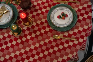 Red checkered tablecloth detail showcasing festive holiday table setting with seasonal decor.