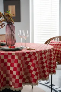 Festive red waterproof round tablecloth with gold lace jacquard design for dining table decor.