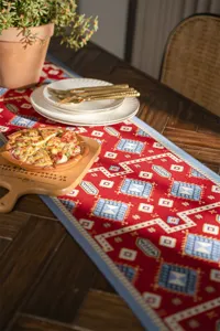 Red jacquard table runner with geometric pattern, festive home decor for dining table.