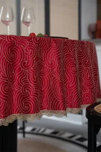 Red jacquard waterproof round tablecloth with gold lace, elegant table detail view.