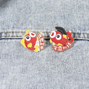 Close-up detail of cute koi fish metal enamel lapel pins with graduation cap design.