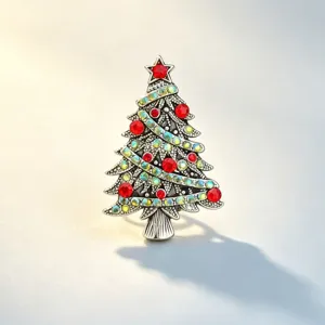 Close-up details of vintage alloy Christmas tree brooch with sparkling holiday crystals.