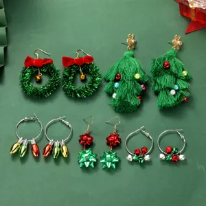 Christmas earrings set detail featuring cute trees, wreaths, bows, and bells designs.