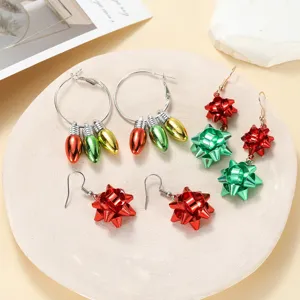 Christmas earrings set featuring festive bulb and bow designs in vibrant red and green colors.