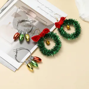 Christmas earrings set featuring festive green tinsel wreaths and colorful bulb hoop designs.