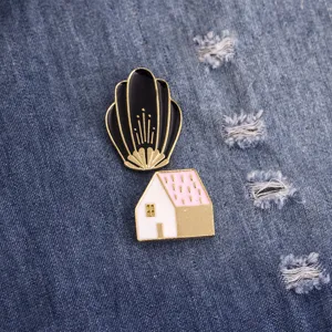 Creative enamel pin set featuring a black shell and pink house design for stylish clothing decor.