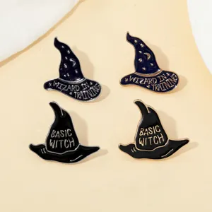 Primer plano detallado de broches de esmalte de sombrero de bruja con diseños de texto de mago.