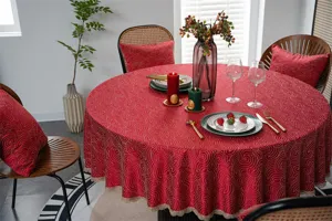 Festive red waterproof round tablecloth detail with elegant gold swirl pattern and delicate lace trim.