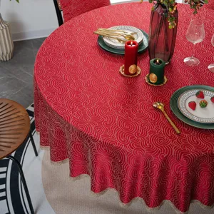 Red jacquard round tablecloth with gold lace border, elegant festive home decor detail.
