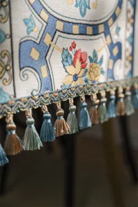Polyester jacquard table runner detail shot featuring elegant geometric floral patterns and colorful tassels.