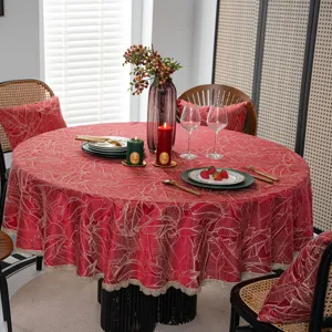 Red jacquard round tablecloth with gold leaf patterns and elegant lace trim for festive dining.