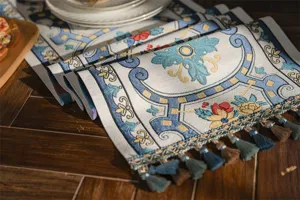 Detailed view of a jacquard table runner with tassels, elegant geometric and floral pattern.