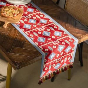 Red geometric table runner with tassels, festive jacquard polyester dining table decor cover.