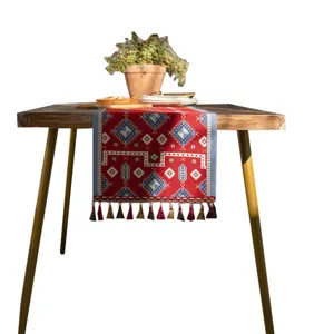 Red geometric polyester table runner with tassels, festive home decor for dining table.