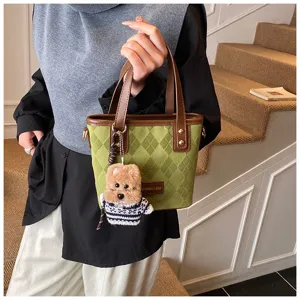 Green quilted tote bag for women, retro canvas shoulder bag with cute bear pendant and top handles.