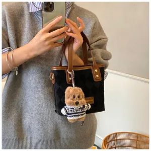 Women vintage quilted shoulder bag with cute teddy bear charm for daily commute.
