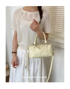 Chic light yellow Boston bag detail, stylish crossbody handbag, premium PU leather accessory.