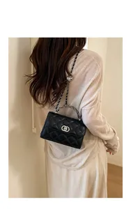 Elegant black quilted chain shoulder bag with metal lock for modern women daily fashion.