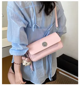 Chic pink shoulder bag for women, stylish minimalist crossbody bag with cute plush pendant.