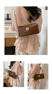 Close-up detail shot of the brown patent leather shoulder bag with chic metal turn lock.