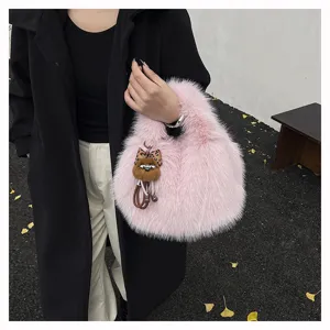 Cute pink fluffy plush handbag detail shot, trendy winter furry tote bag for stylish women.