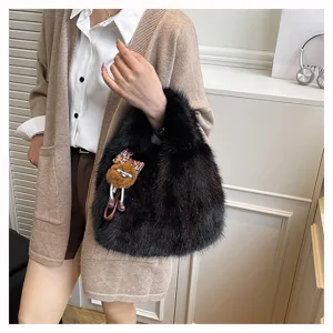 Stylish black faux fur handbag for women, winter fluffy cute tote bag with plush pendant.