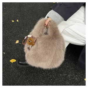 Chic winter furry handbag for women, soft plush tote bag with cute plush pendant detail.