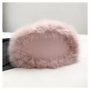 Pink fluffy plush handbag detail, soft winter furry material, elegant women accessory.