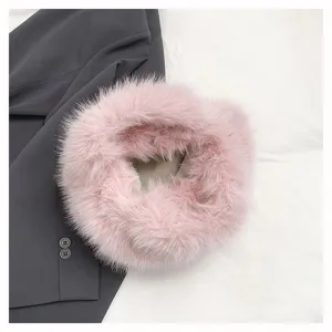 Close-up detail of a cute pink fluffy plush handbag, soft furry texture for winter fashion style.